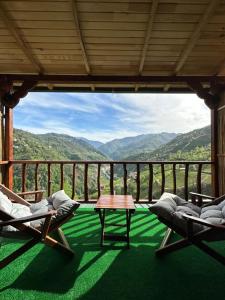 a room with two chairs and a table on a balcony at Zifona Bungalov in Çamlıhemşin