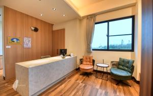 Habitación hospitalaria con recepción y sillas en 漫活時光民宿 Leisure Living, en Baisha