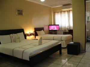 Postel nebo postele na pokoji v ubytování Nkanga Hotel