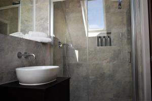 a bathroom with a sink and a glass shower at 17 The Fairways in Broadstairs