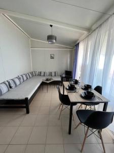 a living room with a couch and tables and chairs at Elia’s house in Ligia