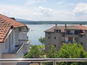 a view of a body of water between buildings at Стаи за гости Мистрал in Primorsko