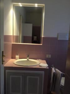 a bathroom with a sink and a mirror at Villa Corneghe in Gargnano