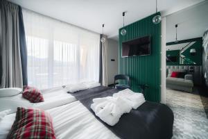 Postel nebo postele na pokoji v ubytování Rysy Boutique Hotel
