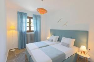 two beds in a room with blue and white at Coconut & Vanilla & Pineapple Pool Apartments #FeelsLikeHome in Kriopigi +51 photos
