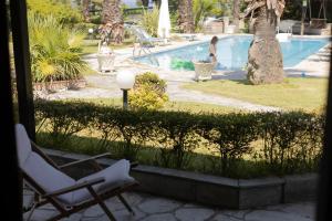 a couple of chairs sitting next to a swimming pool at #FLH - Coconut & Vanilla & Pineapple Pool Apartments in Kriopigi