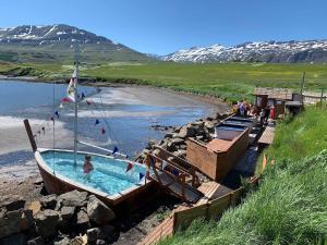 a swimming pool in a boat next to a beach at Beautiful house with amazing sea view. in Dalvík