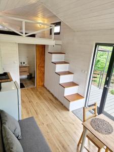 a tiny house with a staircase in a room at Zielona Górka in Biskupiec