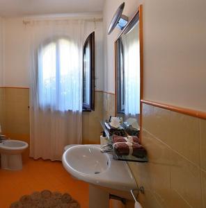 a bathroom with a sink and a toilet at Conero Casa - Marcelli di Numana in Piazzale Tremiti 7 in Marcelli