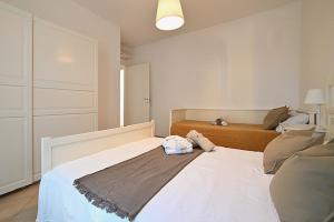 a bedroom with a large white bed with a pillow on it at Conero Casa - Marcelli di Numana in Piazzale Tremiti 7 in Marcelli