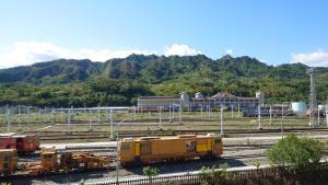 a group of trains on tracks in a train yard at The Railroad Runs in Taitung City
