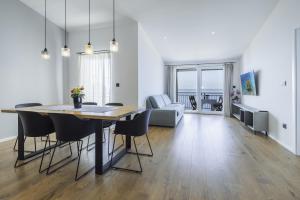 a dining room and living room with a table and chairs at Apartmani Stipe Brela in Brela