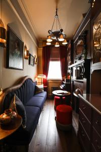 a living room with a couch and a table at Henrys Townhouse Marylebone in London