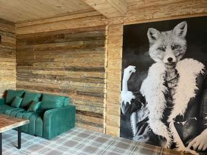 a painting of a wolf on a wall in a living room at Ostoja Spokoju in Olchowiec