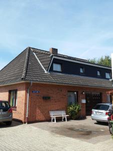 a brick building with a bench in front of it at Haus-Lily-Nr-03 in Büsum