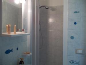 a bathroom with a shower with a glass door at Mare e Monti in Giardini Naxos