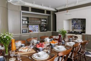 a dining room with a table with food on it at Henrys Townhouse Marylebone, London in London