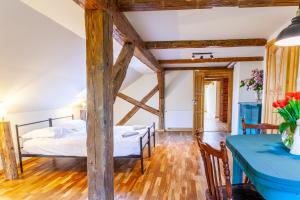 a bedroom with two beds and a table at Zakątek Szczęścia Eko Agroturystyka in Kiwity