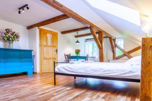 a bedroom with a bed and a blue dresser at Zakątek Szczęścia in Kiwity