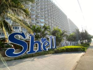 a sign for a hotel in front of a building at Luxury Condo with Pool View at Shell Residences in Manila
