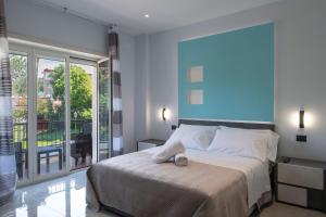 a bedroom with a bed and a large window at Garibaldi Rooms in Portici