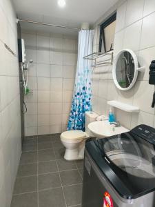 a bathroom with a toilet and a sink at New Cozy The Sun Homestay at Sg Nibong Bayan Lepas Factory Area in Bayan Lepas