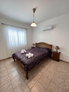 a bedroom with a bed with two towels on it at Pafia Sunbeach Townhouse in Paphos