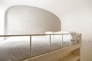 a bedroom with a white bed with a metal frame at Casa Doria by Burghesius in Rome
