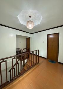 an empty room with a staircase and a ceiling at Rachel’s Bed and Breakfast in Silang