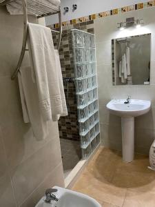 a bathroom with a sink and a toilet and a shower at Habitacion rural en Alora Caminito del Rey in Málaga