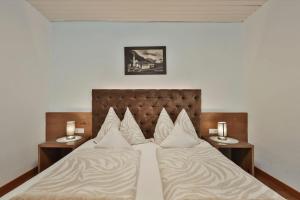 a bedroom with two beds and two tables with candles at Chalet Sofie in Ischgl