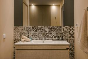 a bathroom with a sink and a mirror at Fileas Art Hotel in Chania