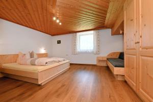a bedroom with two beds and a wooden ceiling at Kraft Christian in Sankt Gallenkirch
