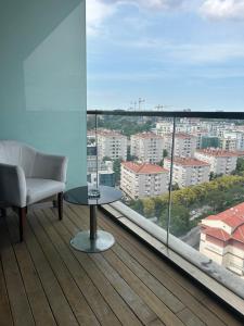 a room with a chair and a table and a large window at Platform merter apartment in Istanbul