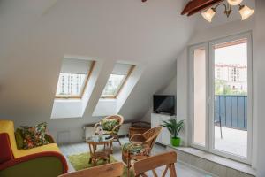 a living room with furniture and a balcony at Pécs City View- free parking in Pécs