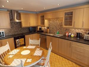 a kitchen with a wooden table and chairs in it at Waterloo Cottage in Barnard Castle