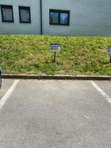 two signs on the side of a road next to a building at Pécs City View- free parking in Pécs +27 photos