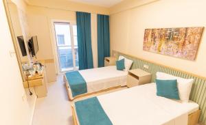 een ziekenhuiskamer met 2 bedden en een raam bij LEVANT HOTEL&APARTS in Çeşme