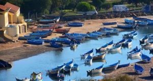 a bunch of boats are lined up on the water at Maison Moulay! in Moulay Bousselham
