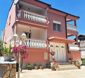 a house with potted plants in front of it at Montenegro Smile in Dobra Voda