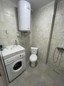 a bathroom with a washing machine and a sink at Europalace Gonio in Gonio