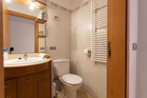 a bathroom with a toilet and a sink at Sa Marina des torrent - Grupo Berna in Ses Salines +40 photos