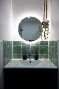 a bathroom with a sink and a mirror at Redbrick’s Bergerac, Au coeur du centre historique in Bergerac +25 photos