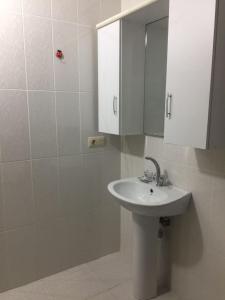 a bathroom with a white sink and a mirror at Rahat ve Konforlu in Araklı