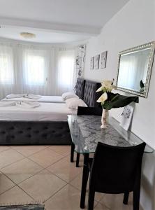 a bedroom with a bed and a table with a table sidx sidx sidx at Montenegro Smile in Dobra Voda