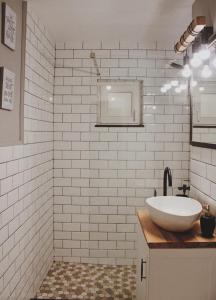 a white bathroom with a sink and a mirror at Cetate boulevard Apartment in Alba Iulia