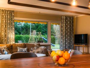 a living room with a table with a bowl of fruit on it at Ferienwohnung Partnacheck in Garmisch-Partenkirchen