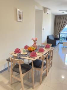 a dining room table and chairs in a living room at 8 Pax Family 100Mbps Kepong DesaPark MontKiara Publika Mitec in Kuala Lumpur