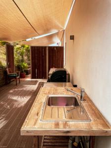 eine Küche mit Spüle auf einer Holzterrasse in der Unterkunft Salthouse Portugal - Exclusive East Apartment in Aljezur