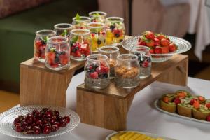 a table topped with bowls of fruit and desserts at Can Font de Muntanya Turisme Rural in Cruïlles